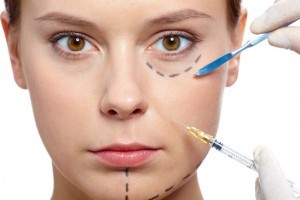 Fresh woman with marks drawn on face during botox procedure